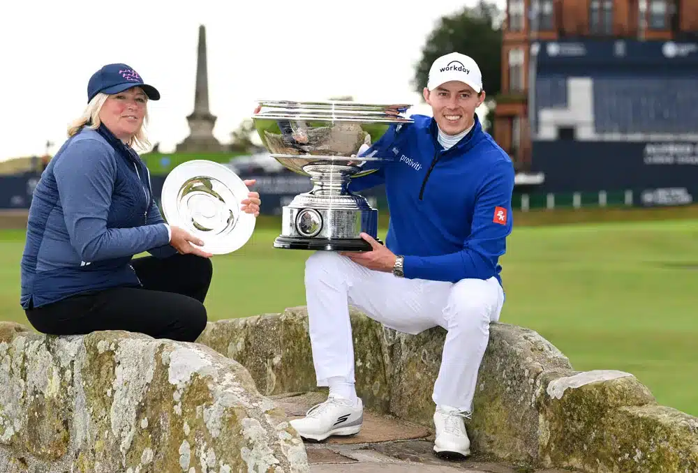 Matt Fitzpatrick of England poses with the trophy on the Swilcan Bridge alongside his Mother and playing partner, Susan Fitzpatrick following his victory and their team victory Day Five of the Alfred Dunhill Links Championship at the Old Course St. Andrews on October 09, 2023 in St Andrews, Scotland.